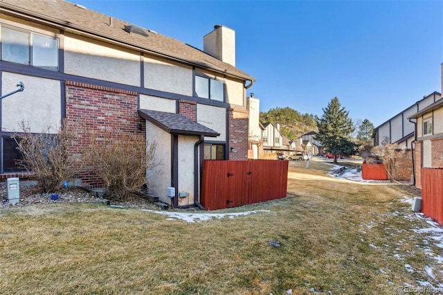 rear view of property featuring a lawn