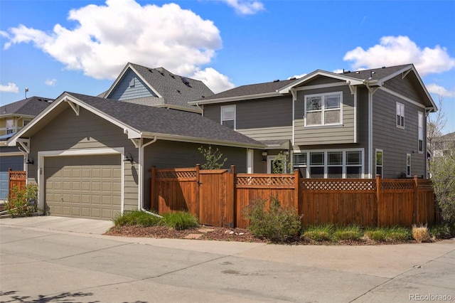craftsman house with fence private yard, an attached garage, and driveway