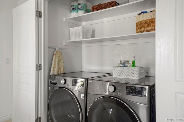 laundry room featuring washing machine and clothes dryer and laundry area