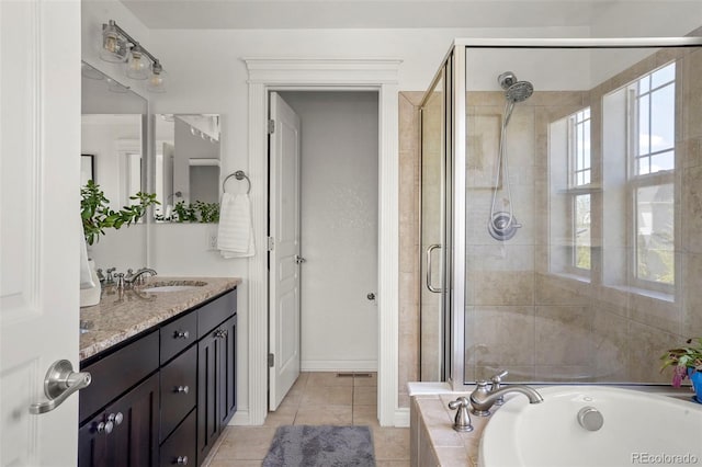 full bathroom with a stall shower, tile patterned flooring, a garden tub, and vanity