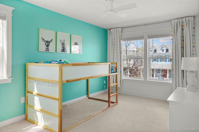 carpeted bedroom with baseboards and a ceiling fan