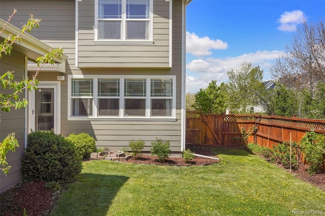 view of side of property featuring a yard and fence