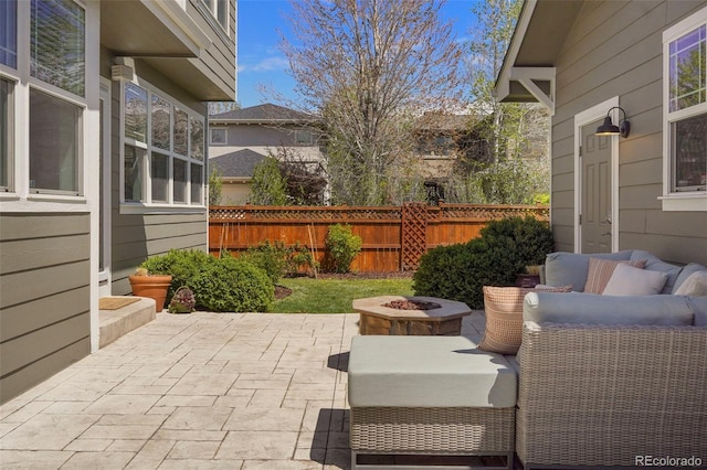 view of patio / terrace featuring an outdoor living space with a fire pit and fence