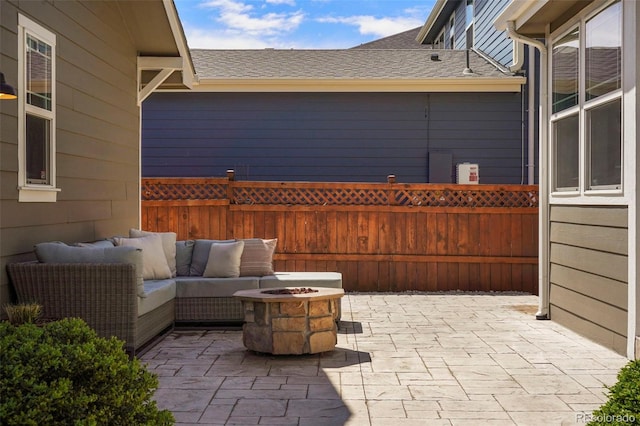 view of patio featuring an outdoor living space with a fire pit and fence
