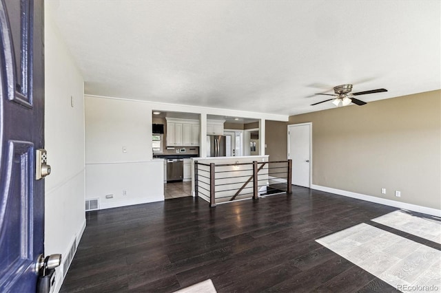 8641 Lowell Blvd, Westminster, CO 80031 - unfurnished living room featuring a ceiling fan, wood finished floors, and baseboards