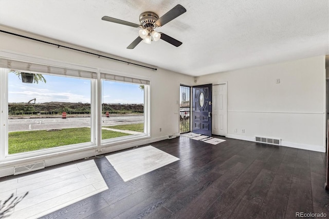 8641 Lowell Blvd, Westminster, CO 80031 - unfurnished room with ceiling fan, dark wood finished floors, baseboards, and a textured ceiling