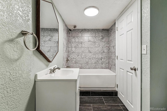 8641 Lowell Blvd, Westminster, CO 80031 - bathroom featuring vanity, a textured wall, and shower / tub combination