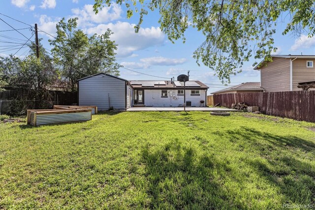 8641 Lowell Blvd, Westminster, CO 80031 - rear view of property with roof mounted solar panels, a garden, and a patio
