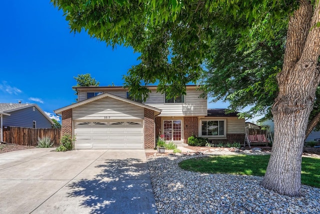 3317 S Elkhart St, Aurora, CO 80014 - traditional-style home featuring brick siding, driveway, and a garage