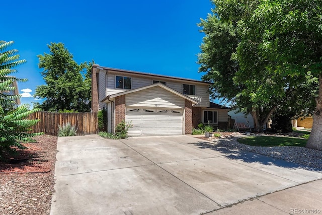 3317 S Elkhart St, Aurora, CO 80014 - traditional-style home with brick siding, driveway, and an attached garage