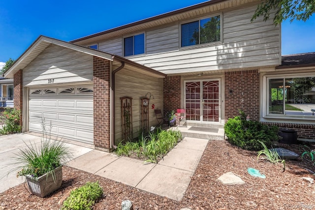 3317 S Elkhart St, Aurora, CO 80014 - view of front facade with brick siding, a garage, and driveway
