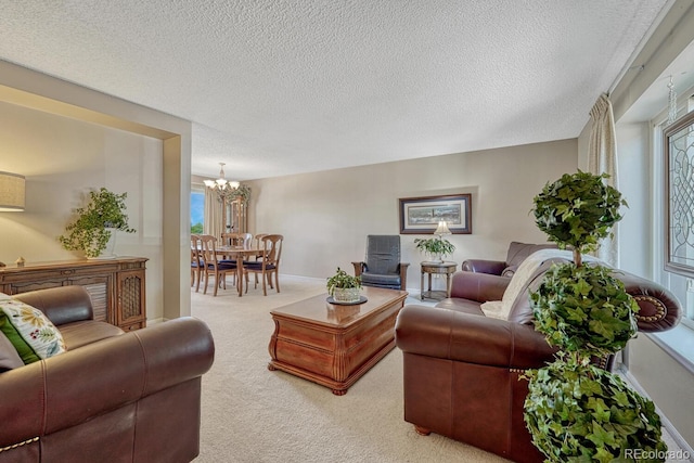 3317 S Elkhart St, Aurora, CO 80014 - carpeted living area featuring a textured ceiling and a chandelier