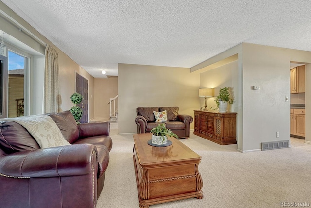 3317 S Elkhart St, Aurora, CO 80014 - living area featuring light carpet, a textured ceiling, and stairway