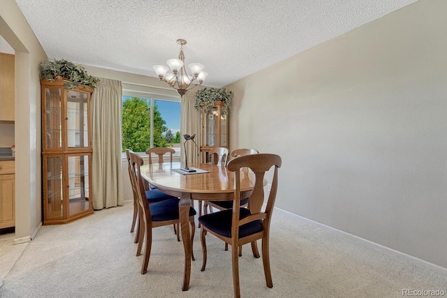 3317 S Elkhart St, Aurora, CO 80014 - dining space featuring a chandelier, light carpet, and a textured ceiling