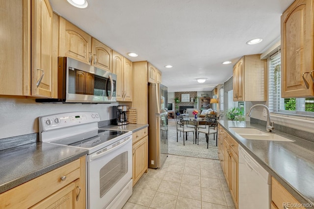 3317 S Elkhart St, Aurora, CO 80014 - kitchen with appliances with stainless steel finishes, dark countertops, light brown cabinetry, recessed lighting, and light tile patterned flooring