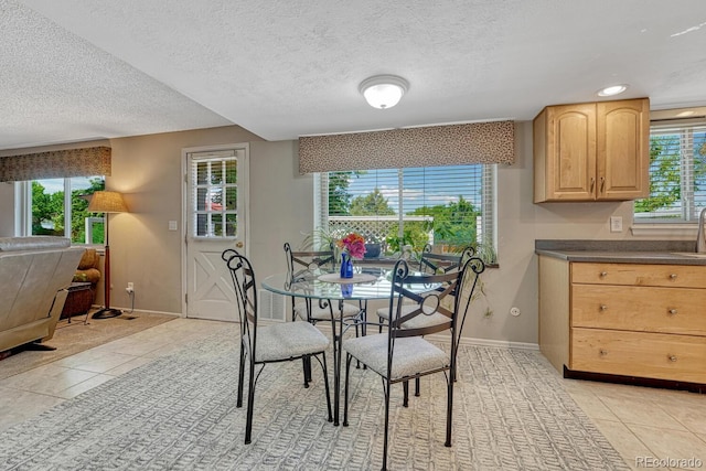 3317 S Elkhart St, Aurora, CO 80014 - dining room with light tile patterned flooring and a textured ceiling