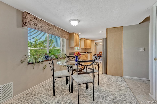 3317 S Elkhart St, Aurora, CO 80014 - dining room featuring recessed lighting and a textured ceiling