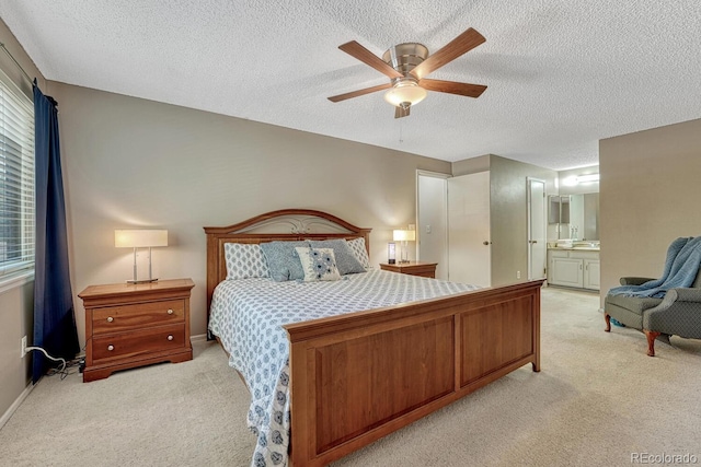 3317 S Elkhart St, Aurora, CO 80014 - bedroom with light carpet, a textured ceiling, ensuite bathroom, and ceiling fan