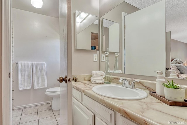3317 S Elkhart St, Aurora, CO 80014 - bathroom with vanity, tile patterned flooring, and a textured ceiling