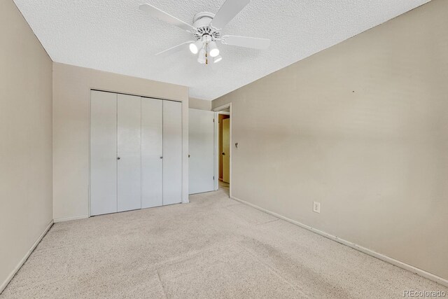 3317 S Elkhart St, Aurora, CO 80014 - unfurnished bedroom with carpet flooring, a closet, a textured ceiling, and a ceiling fan