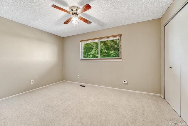 3317 S Elkhart St, Aurora, CO 80014 - unfurnished bedroom with a closet, carpet, a textured ceiling, and a ceiling fan