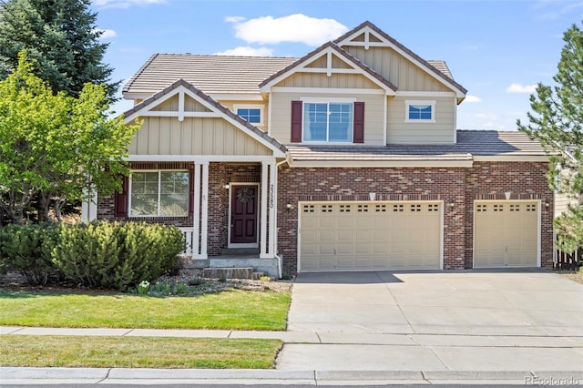 23580 E Portland Way, Aurora, CO 80016 - craftsman-style house featuring brick siding, driveway, board and batten siding, and a front lawn