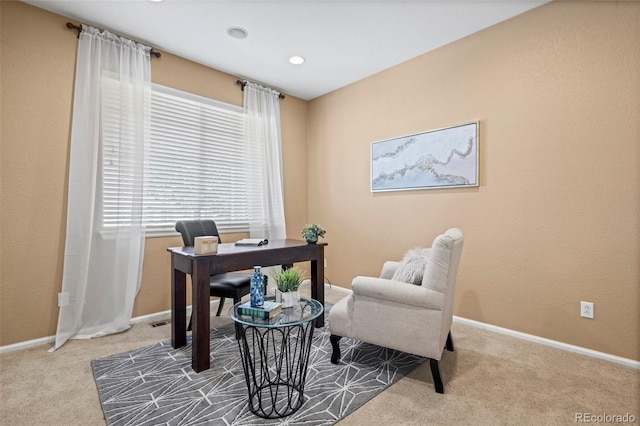 carpeted office space featuring baseboards