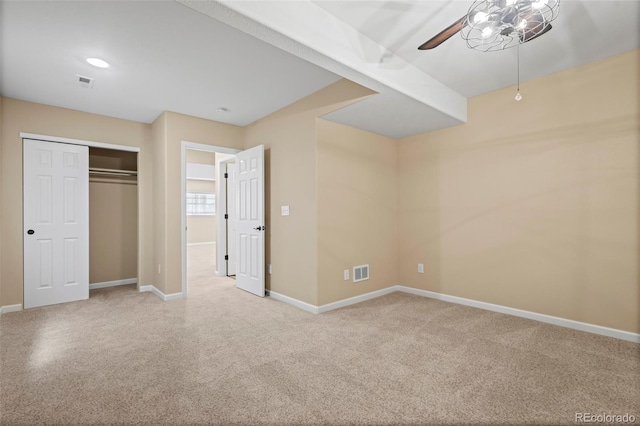 unfurnished bedroom with visible vents, a closet, baseboards, a ceiling fan, and carpet