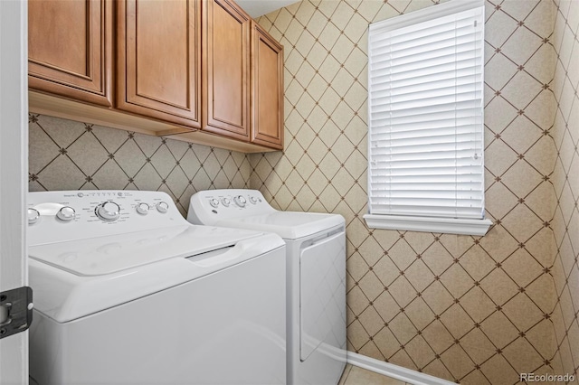 laundry area with washer and clothes dryer and cabinet space