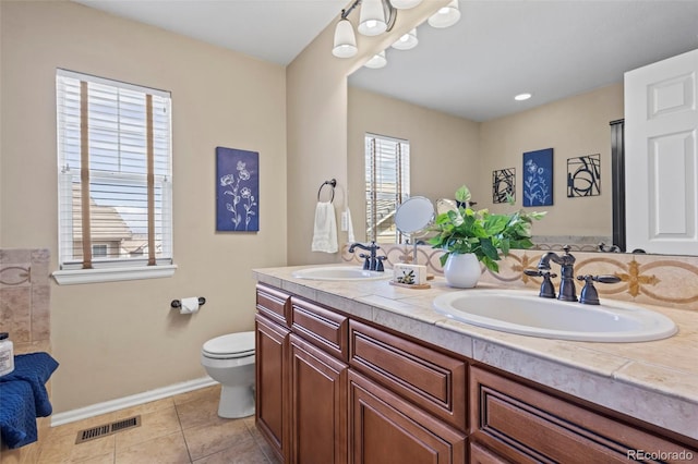 full bathroom featuring visible vents, a sink, tile patterned floors, and double vanity