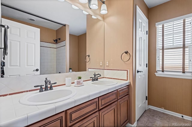 bathroom with double vanity, plenty of natural light, and a sink