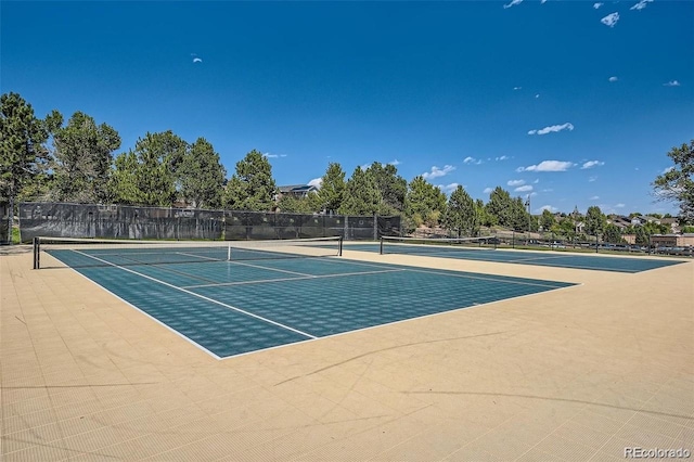 view of tennis court with fence and community basketball court
