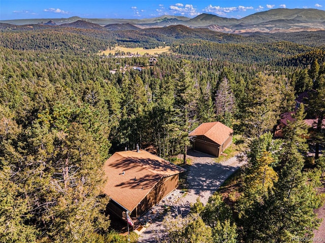 aerial view with a mountain view and a view of trees