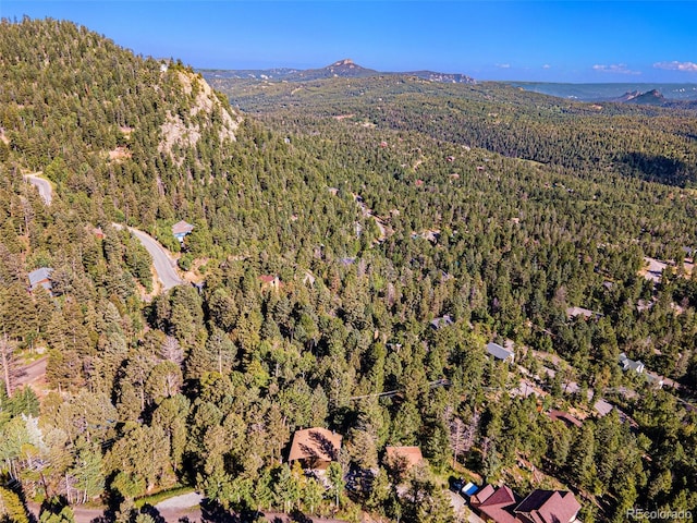 birds eye view of property with a mountain view and a view of trees