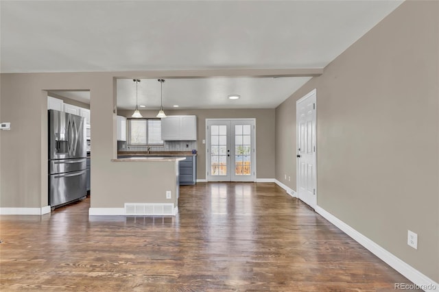 kitchen with visible vents, white cabinets, french doors, and stainless steel fridge with ice dispenser