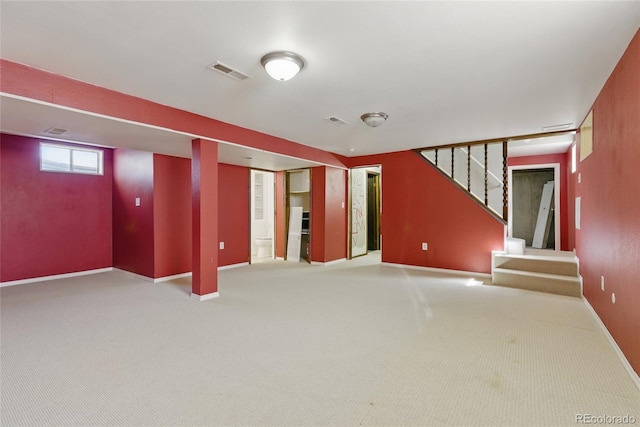 basement featuring stairway, baseboards, visible vents, and carpet floors