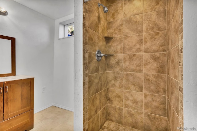 full bathroom with vanity and a tile shower