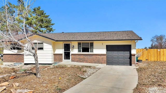 ranch-style house with fence, driveway, roof with shingles, a garage, and brick siding