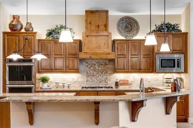 7992 Rising Sun Ct, Windsor, CO 80550 - kitchen with stainless steel appliances, tasteful backsplash, a kitchen breakfast bar, light stone countertops, and brown cabinets