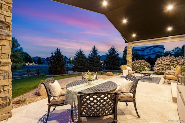 7992 Rising Sun Ct, Windsor, CO 80550 - patio terrace at dusk featuring a patio area and outdoor dining space