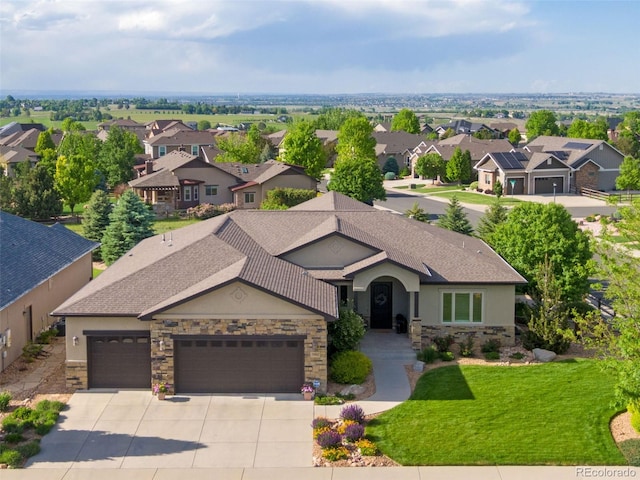 7992 Rising Sun Ct, Windsor, CO 80550 - view of front facade with stone siding, stucco siding, and a garage