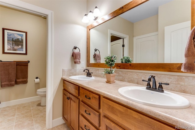 7992 Rising Sun Ct, Windsor, CO 80550 - bathroom featuring double vanity, toilet, baseboards, and tile patterned floors