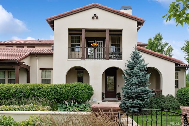 8526 E 35th Ave, Denver, CO 80238 - mediterranean / spanish house with a chimney, a balcony, and a tiled roof