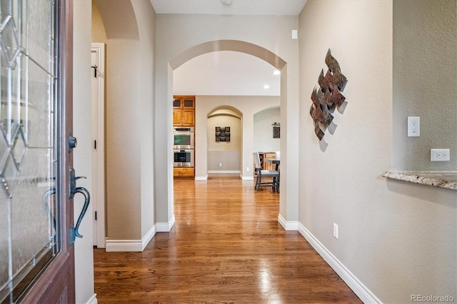8526 E 35th Ave, Denver, CO 80238 - foyer featuring arched walkways, wood finished floors, and a textured wall