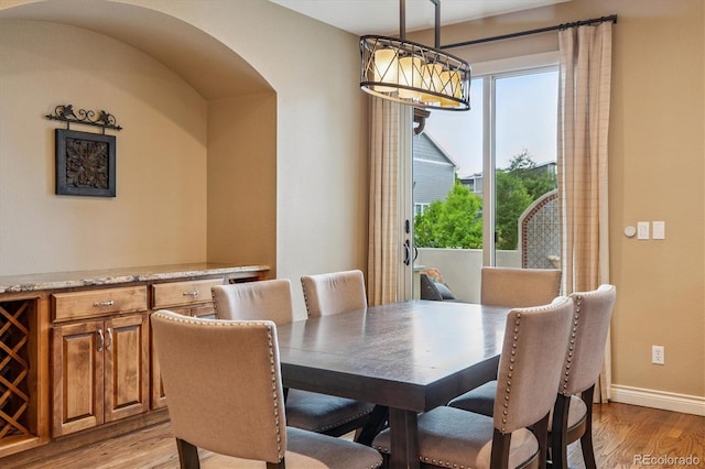 8526 E 35th Ave, Denver, CO 80238 - dining space featuring light wood-type flooring and arched walkways