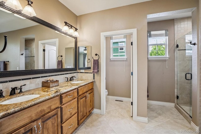 8526 E 35th Ave, Denver, CO 80238 - bathroom with double vanity, decorative backsplash, a stall shower, and tile patterned floors