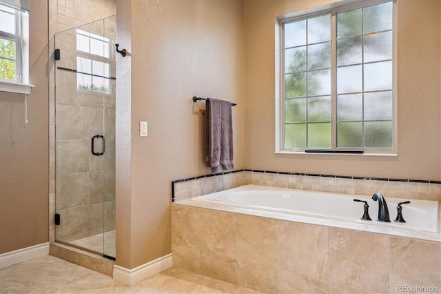8526 E 35th Ave, Denver, CO 80238 - full bathroom featuring a garden tub, a shower stall, tile patterned floors, and a textured wall