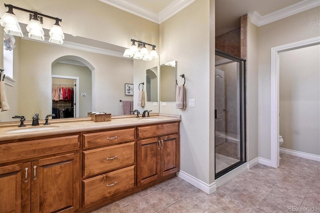8526 E 35th Ave, Denver, CO 80238 - bathroom with ornamental molding, a shower stall, double vanity, a walk in closet, and tile patterned flooring
