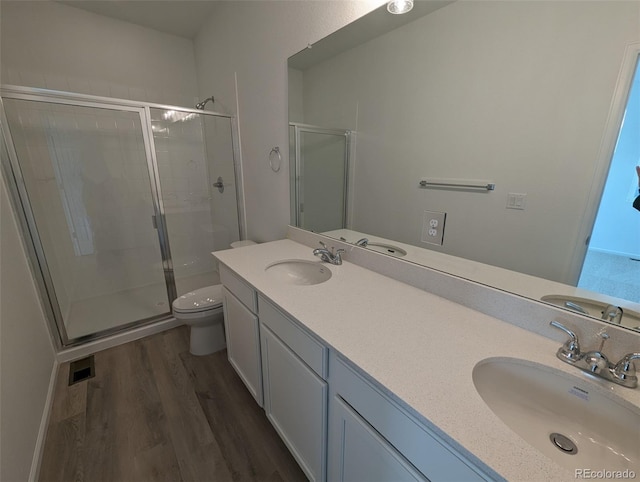 bathroom featuring wood-type flooring, an enclosed shower, and toilet