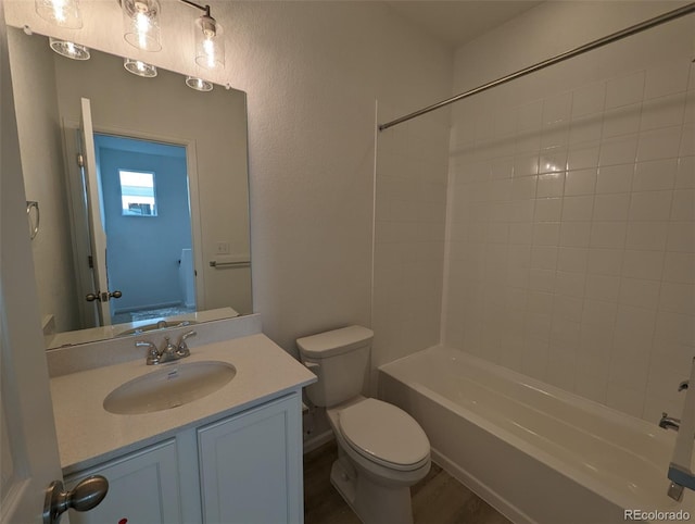 full bathroom with vanity, hardwood / wood-style floors,  shower combination, and toilet